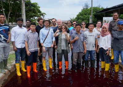 REEF Fellow Suzan Shahrestani poses with a group at a shrimp farm