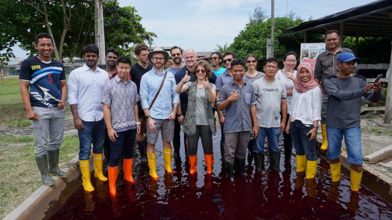 REEF Fellow Suzan Shahrestani poses with a group at a shrimp farm