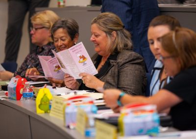 Carole Ratcliffe and judges looking at menus at AACC Pitch Competition